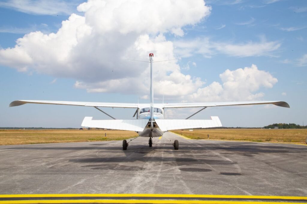 Rear view of a small aircraft on a sunny runway in Visby, Sweden.