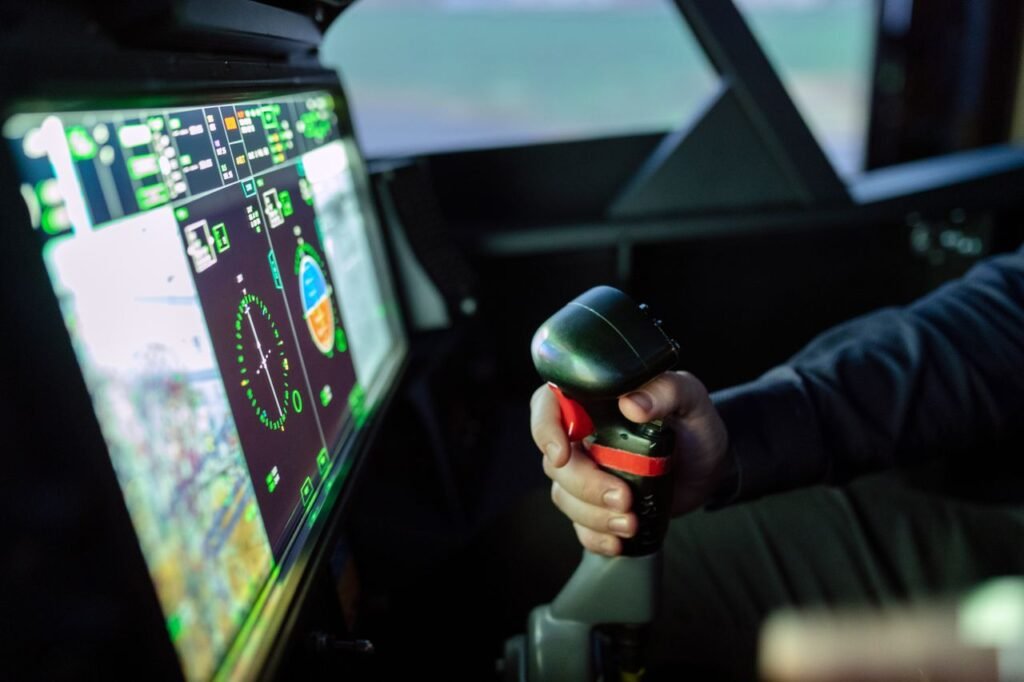 Close-up of a simulated aircraft cockpit with control joystick and digital display.
