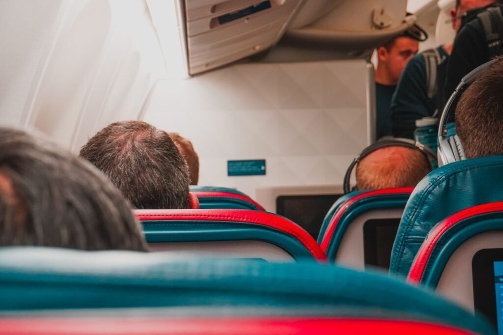 Interior view of an airplane cabin with passengers seated, focusing on seats and layout.